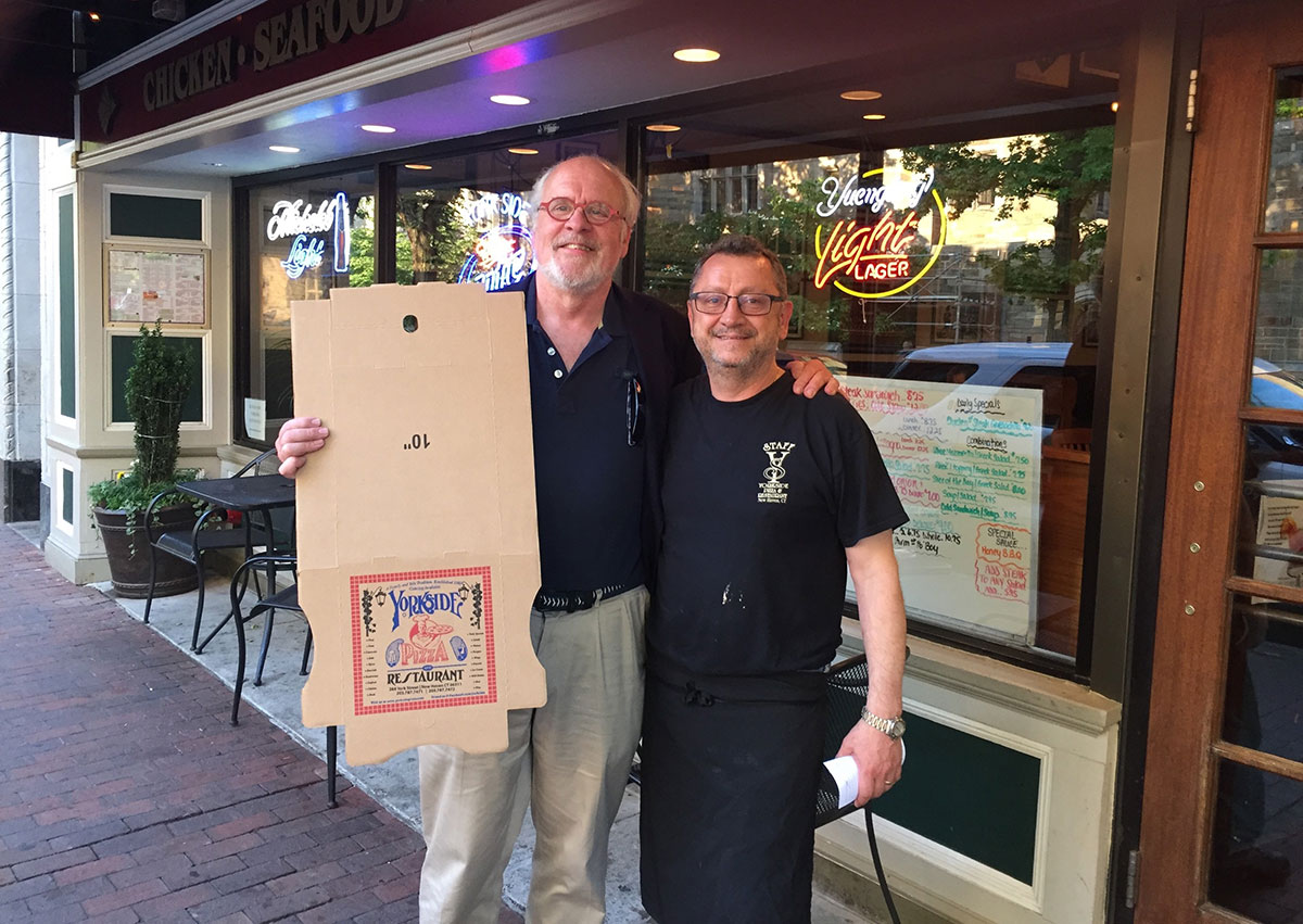 John Danner in front of a pizza restaurant image