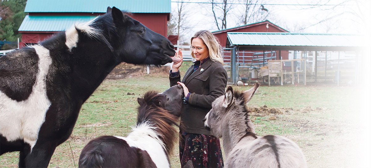 Scarlett with horses on farm