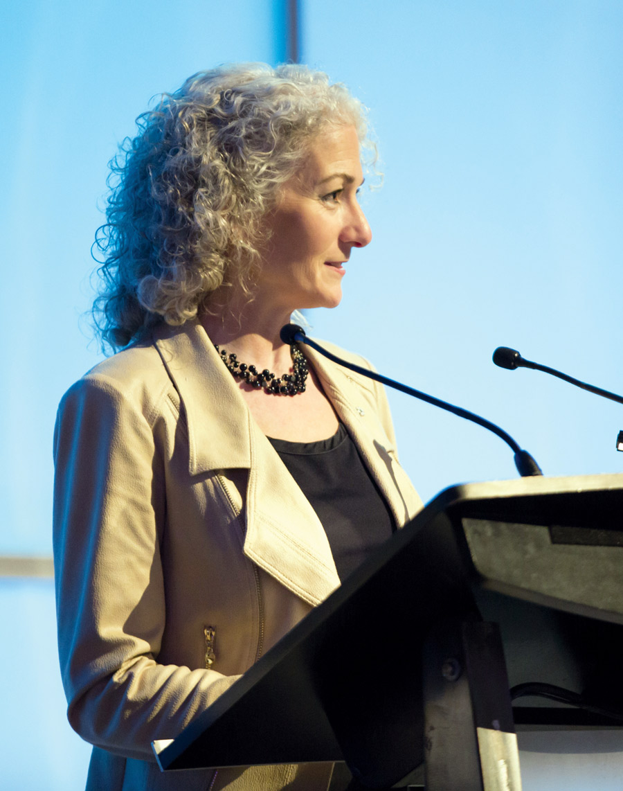 Dr. Bonnie Schmidt standing at a podium