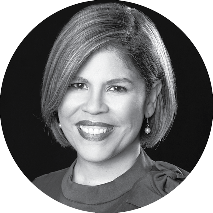 A portrait black and white circular headshot photograph of Raquel Rivera Torres smiling